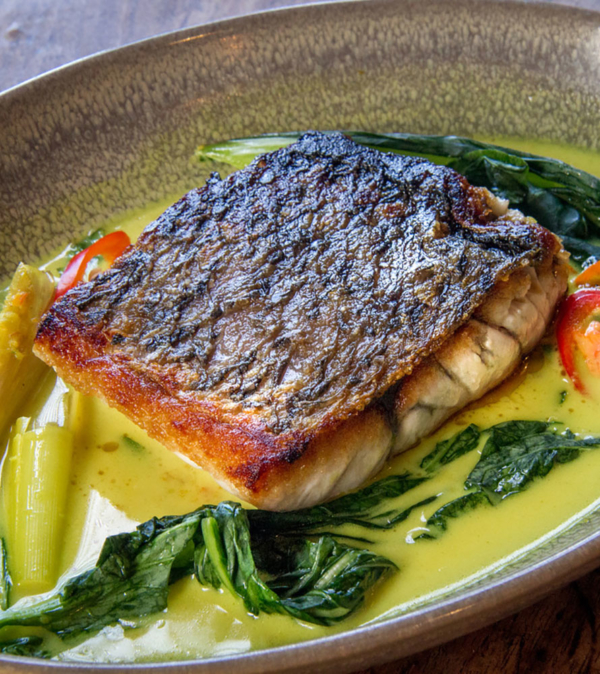 Crispy skin barramundi in yellow fragrant broth, with lemongrass, galangal and Thai basil
