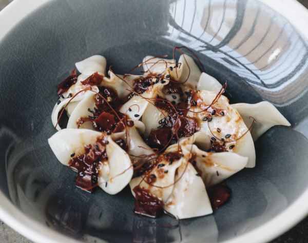 Pork and garlic chive dumplings with dry chilli and Sichuan pepper sauce